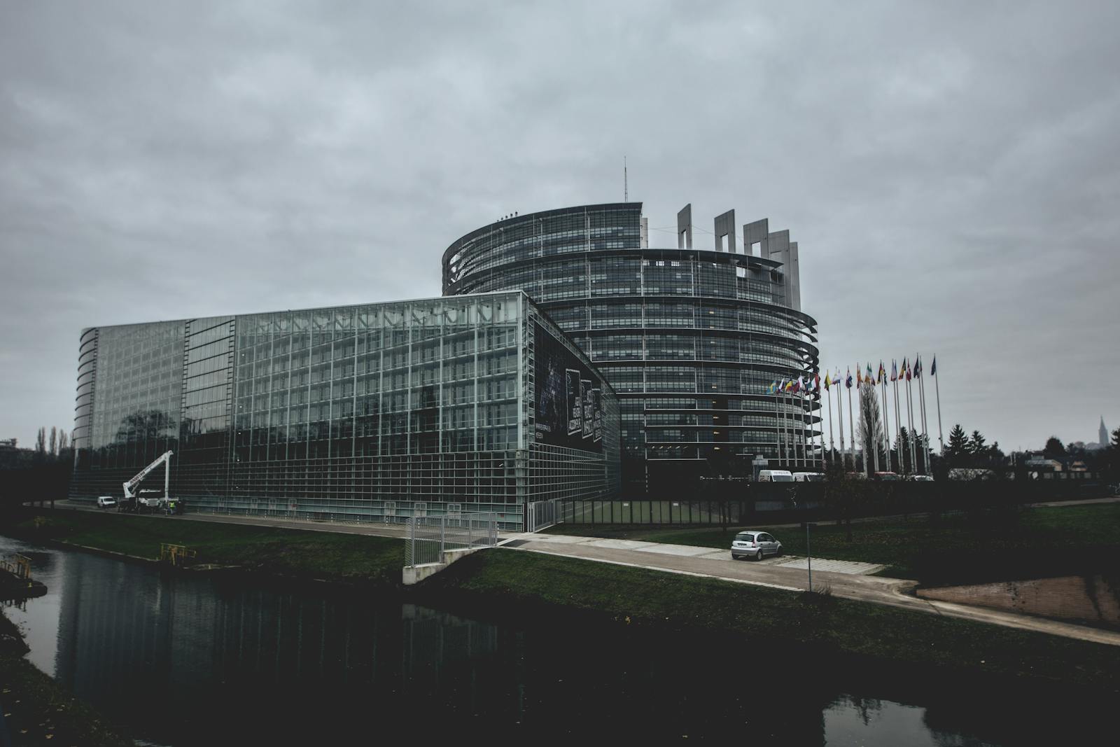 Modern architecture of the European Parliament in Strasbourg on a cloudy day.