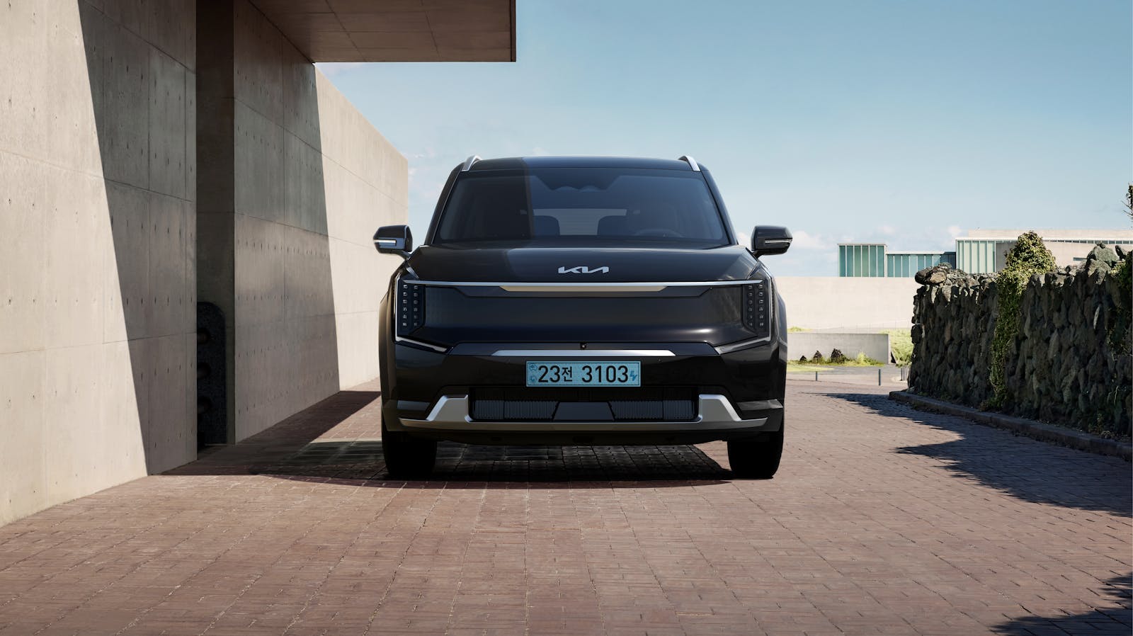 Sleek black electric SUV parked in a contemporary architectural environment.