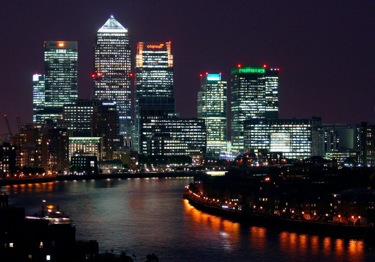 Beautiful nighttime view of Canary Wharf, London, with reflections on the River Thames.
