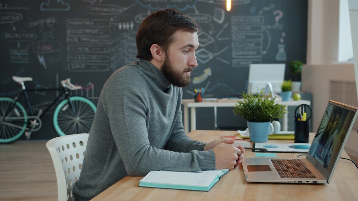 Man working on laptop in modern office space