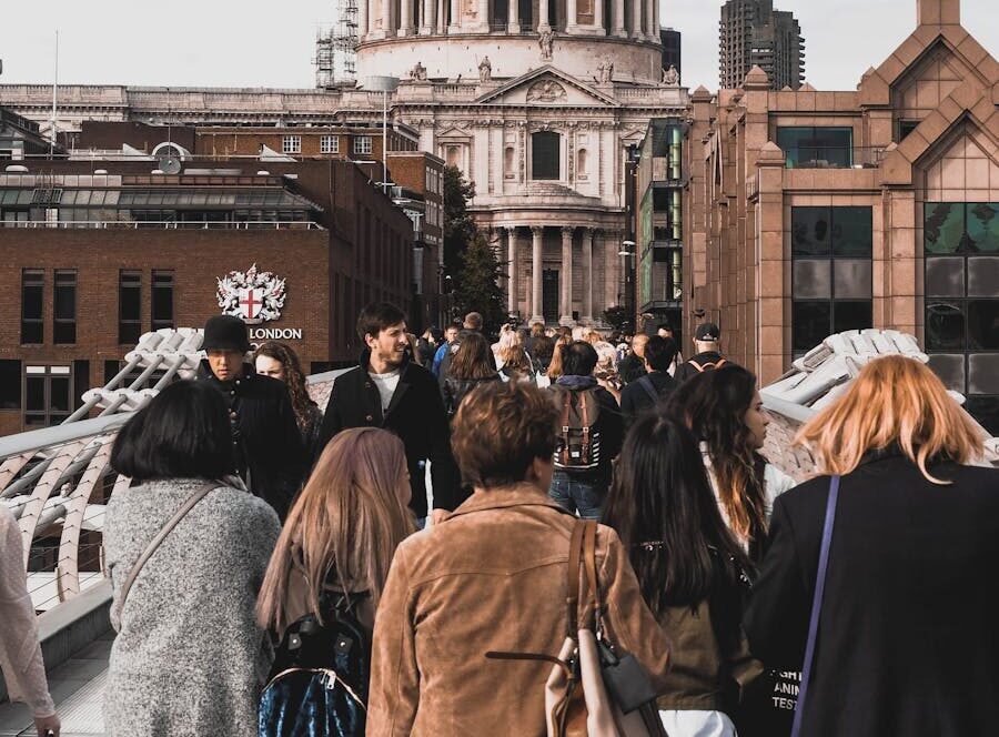 A stunning view of St. Paul's Cathedral captured from Millennium Bridge in London, with people in the foreground.